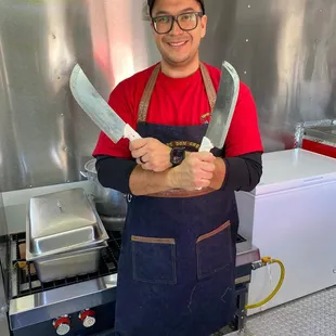 a man holding two knives