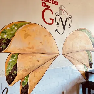 two tacos on a wall
