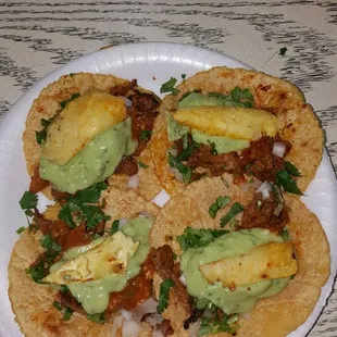 Tacos al pastor with pineapple. The salsa with guacamole is real good.