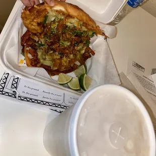 a person grabbing a slice of pizza