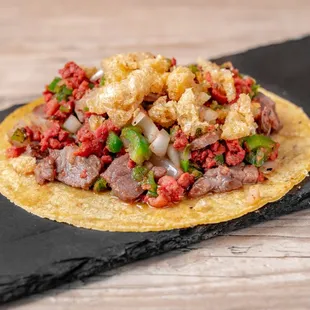 Taco Costeño (mix of cecina, longaniza, onions, jalapeño peppers and crunchy chicharron)