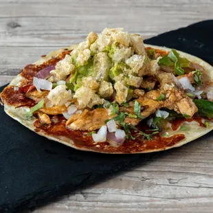 Chicken Estocada - Flour tortilla with a cheese crust, top with your choice of protein, onion, cilantro and guacamole