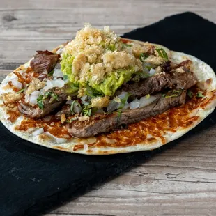 Ribeye Estocada - Flour tortilla with a cheese crust, with your choice of protein, onion, cilantro and guacamole. 
You want to try this!