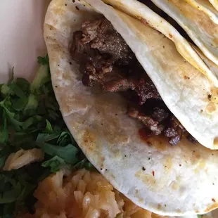 Carne Asada Tacos, absolutely delicious. Not dry and full of flavor, rice and beans are great too.