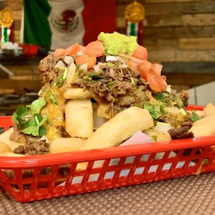 Carne Asada Fries. Loaded with slow-cooked beans, cheese, sour cream and guac.