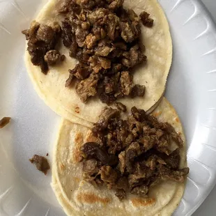 they serve plain tacos and let you top them at their well stocked condiment bar. asada was cooked perfectly.