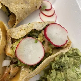 a plate of tacos and guacamole