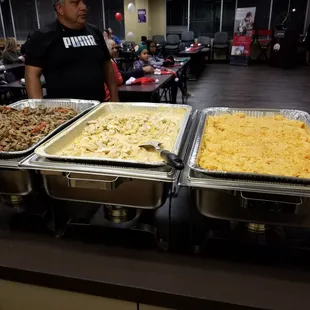 a man standing in front of a buffet