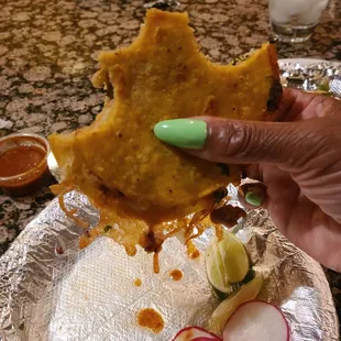 a hand holding a piece of food