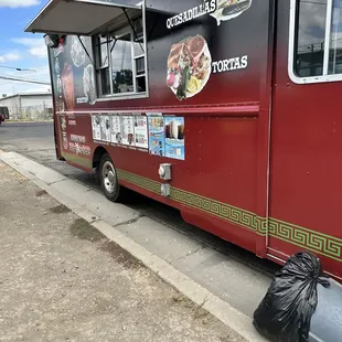 a taco truck parked on the side of the road