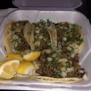 4 carne asada tacos with green sauce , everything on it!