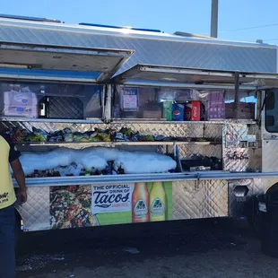 a man and a woman standing in front of a food truck