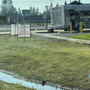 Taco truck and signs for breakfast