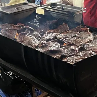 a grill with meat cooking on it