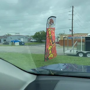 a taco stand in a parking lot