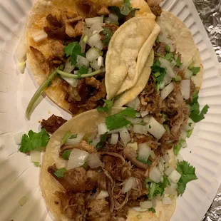 Two carnitas tacos and one spicy pork taco