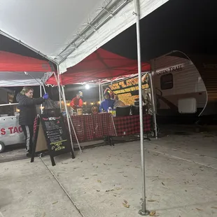 a woman standing under a tent