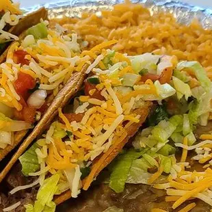 a plate of tacos and rice
