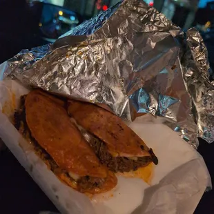 a sandwich wrapped in aluminum foil