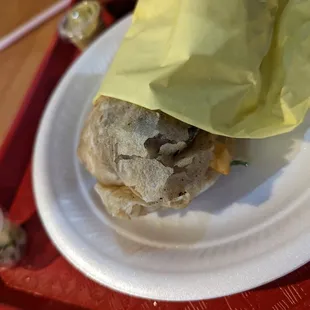 a sandwich wrapped in paper