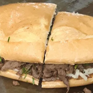 a beef sandwich cut in half