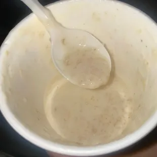 a person holding a spoon in a bowl