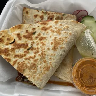 a tortilla and cucumber in a styrofoam container