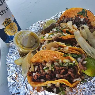 a beer and a plate of tacos