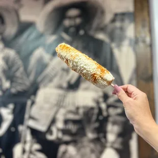 a hand holding a piece of food