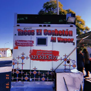 a taco truck parked on the side of the road