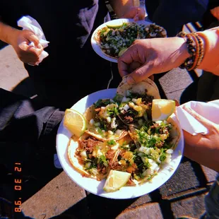 a group of people holding plates of food