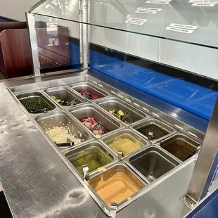 Salsa bar, clean and cold with many options