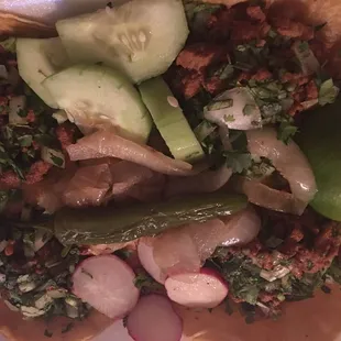 Tacos Al Pastor (my fav) and all of the tacos comes with slices of cucumber, grilled onions, rabanos, lime, and serrano pepper grilled.