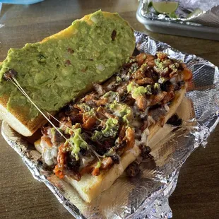 a hot dog with guacamole