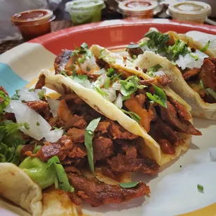 Tacos al pastor are delish!  Tried one with each of their salsas.