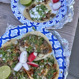 Birria, carne asada, cabeza and al pastor tacos. 2 of them with sour cream for the kiddo.