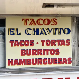 a taco truck with a sign that says tacos tortas burritos hamburgers