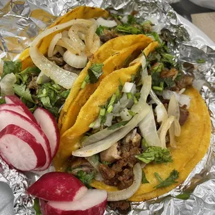 a plate of tacos and radishes