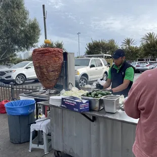 a man preparing food on a cart