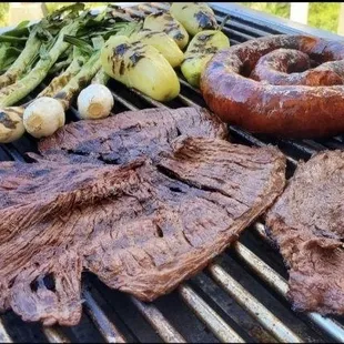 a grill with meat and vegetables