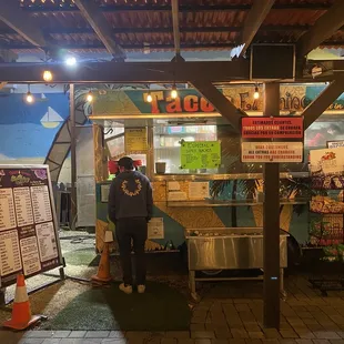 a man standing in front of a food truck