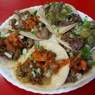 Tacos ($1.39 mostly). Starting at 12 o&apos;clock: lengua (+$0.25), cabeza, asada, al pastor, tripas, buche
