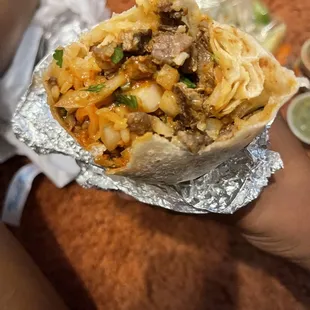 a person holding a burrito