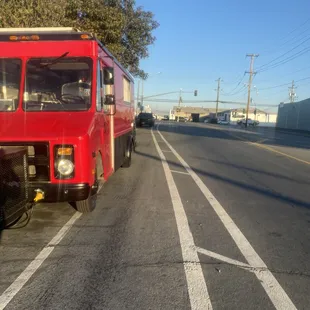 a red truck parked on the side of the road