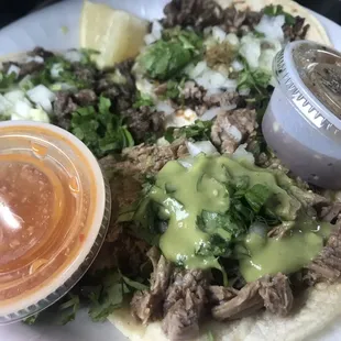 a plate of tacos with sauce