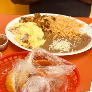 a man sitting at a table with plates of food