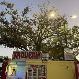 a taqueria with a tree in the background