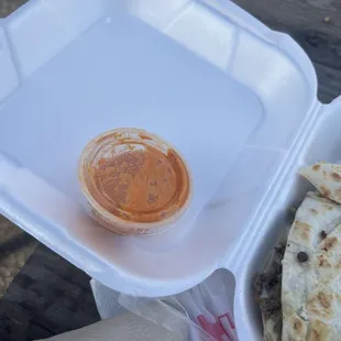 a plate of quesadillas and a bowl of salsa