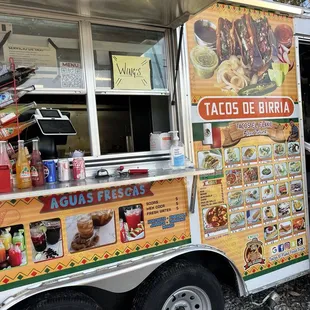a food truck with a menu on the side
