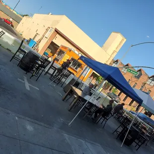 tables and chairs on the sidewalk